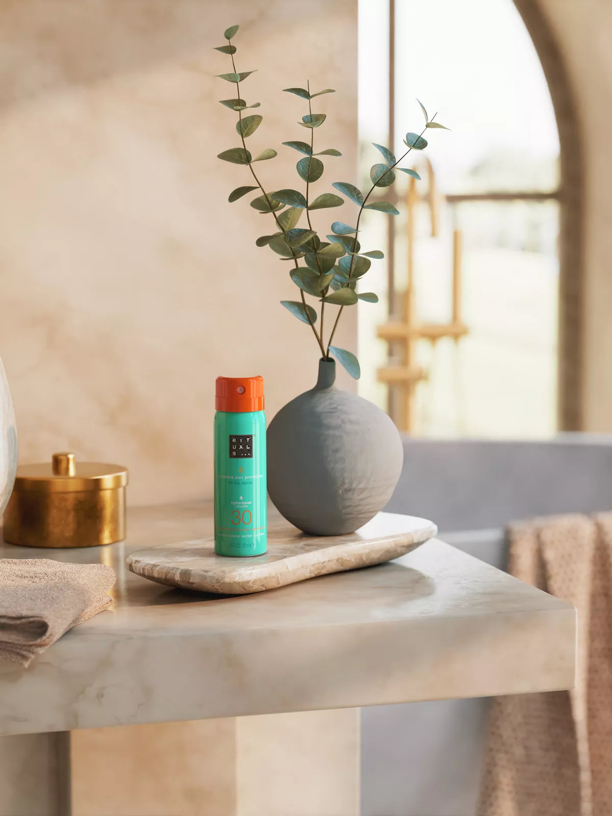 The Ritual of Karma Sun Protection Milky Spray 30 50ml Lifestyle with Product